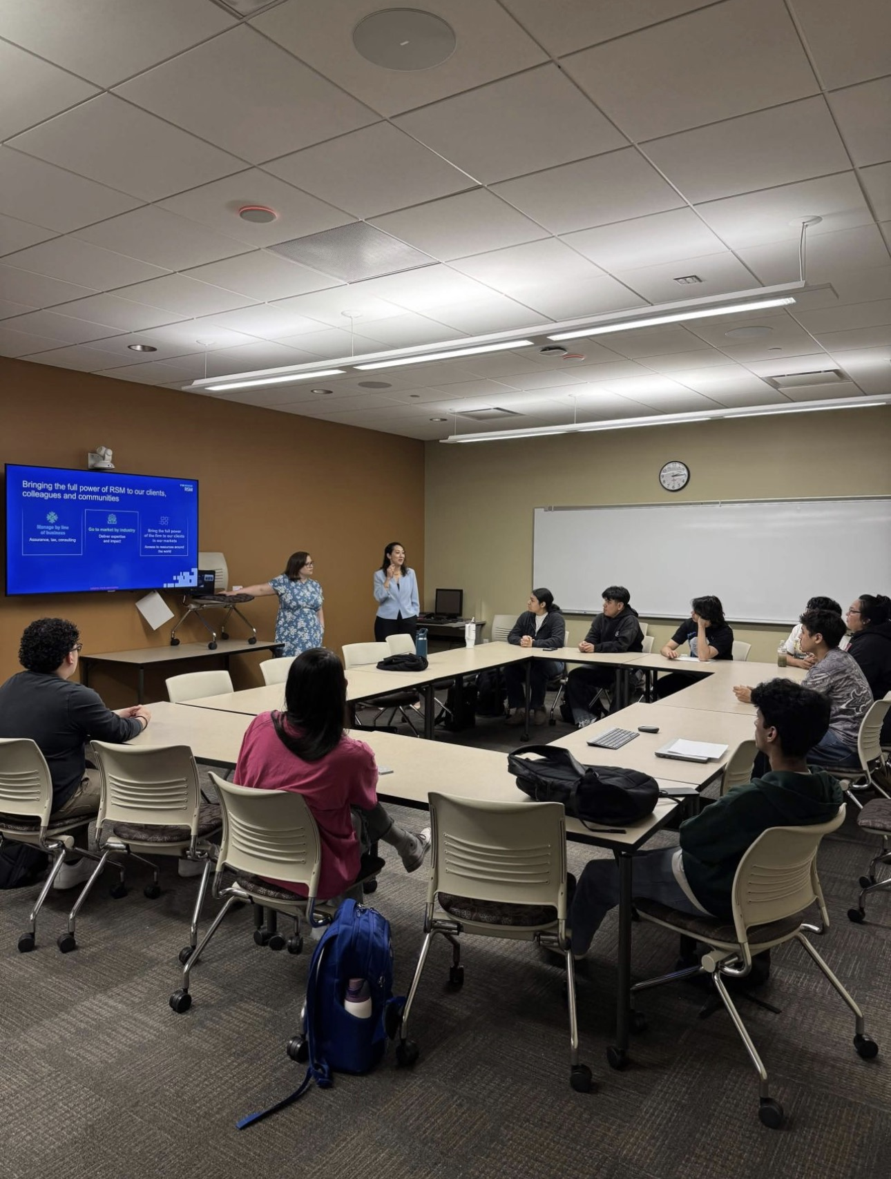 Presenters, RSM presentation screen, and participating ECC students at a past club meeting